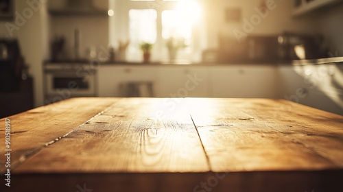 A plain, bare wooden table sits in a well-lit kitchen. The background is a blur of bright white and warm golden sunlight.