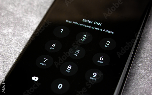 PIN code on the smartphone screen. Locked smartphone screen with password, pin code, password input.