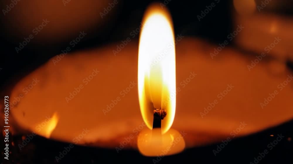 A warm candle flame flickers softly, casting a gentle glow in the dimly lit space, creating a serene atmosphere for relaxation A warm candle flame flickers softly, casting a gentle glow in the dimly lit space, creating a serene atmosphere for relaxation