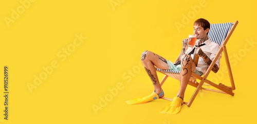 Young tattooed man drinking...