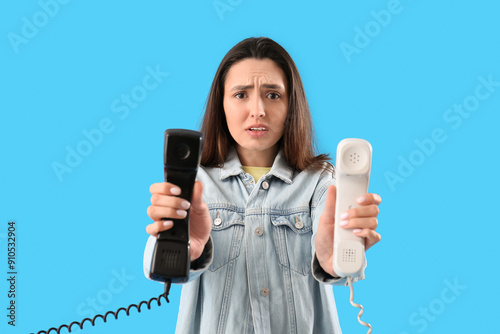 Sad young woman with teleph...