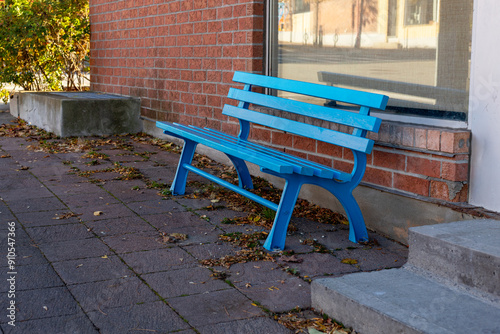 The bench near the wall is embedded in a concrete base, painted in yellow and blue colors.