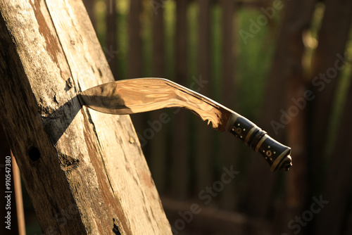 Nepalese Kukri in a wood photo