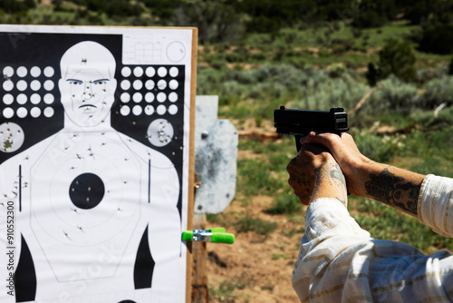 Woman holding gun in front of target