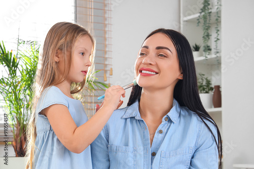 Little girl applying makeup...