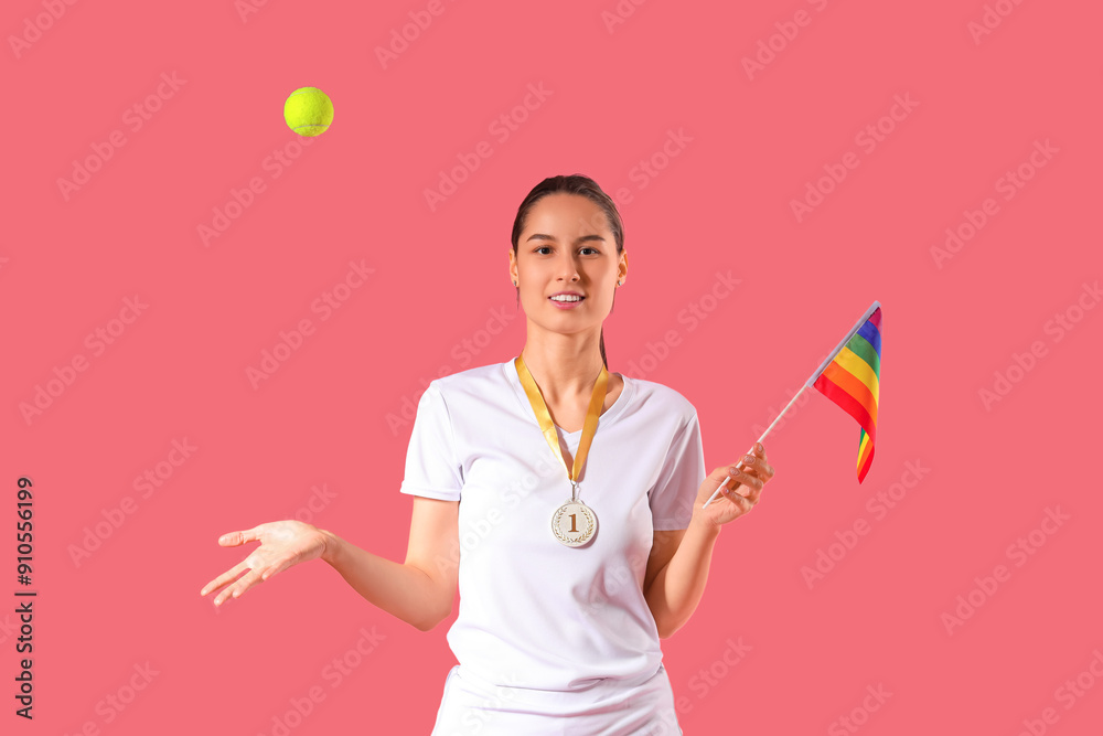 Female tennis player with LGBT flag throwing ball on pink background Female tennis player with LGBT flag throwing ball on pink background