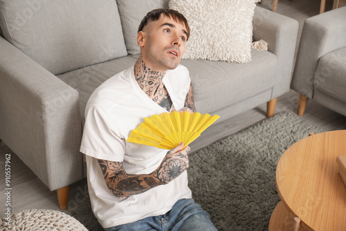 Young tattooed man with han...
