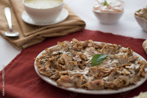 Arab eastern shawarma plate with tahini on it. photo