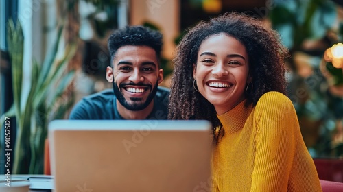 Happy entrepreneurs smiling while planning their business strategy on a laptop