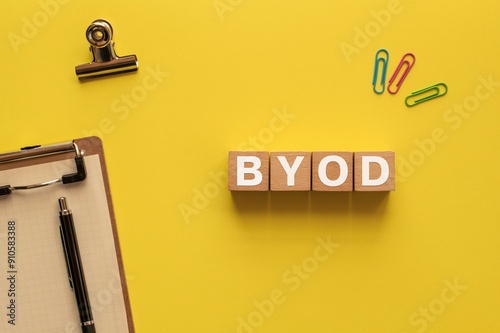 There is wood block with the word BYOD. It is an abbreviation for Bring Your Own Device as eye-catching image. photo