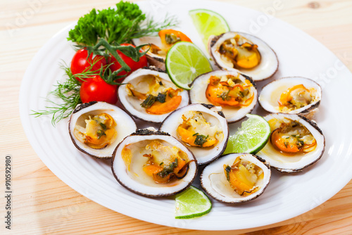 European bittersweet clam appetizers with lime, greens and vegetables photo