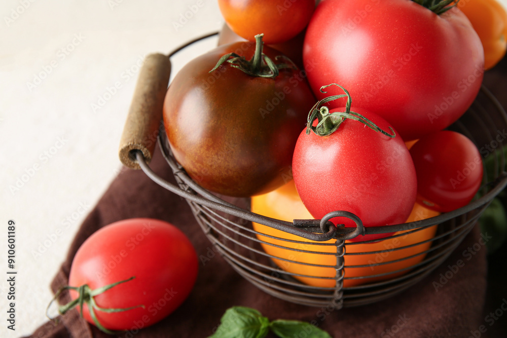 Tomatoes in bowl on cloth on table against white background. Closeup Tomatoes in bowl on cloth on table against white background. Closeup