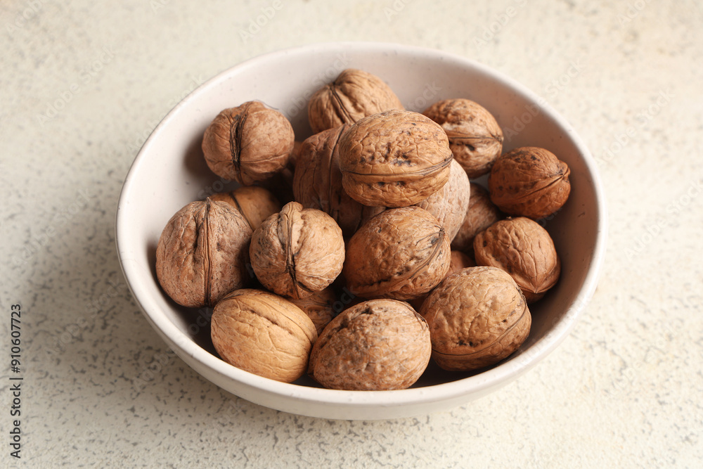 Bowl with tasty walnuts on white background Bowl with tasty walnuts on white background