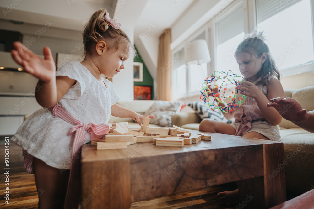 Young sisters engaging in playful activities with toys in a well-lit, cozy living room. Capturing the joy and connection of childhood playtime.