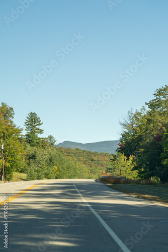 A winding road with view of mountains in White Mountain National Forest.