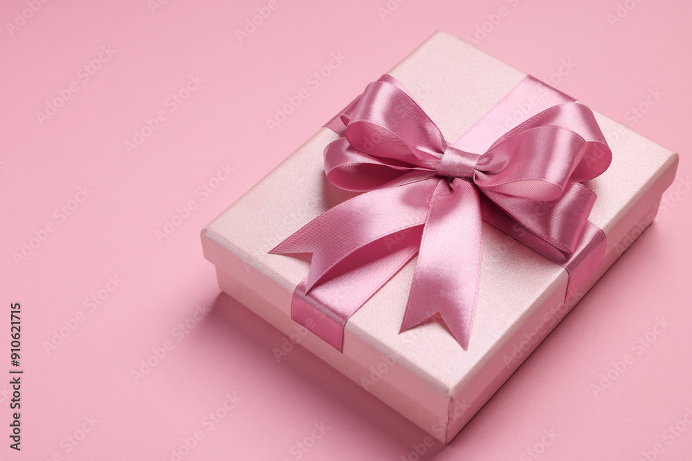 Beautiful gift box with color bow on pink background. Space for text Beautiful gift box with color bow on pink background. Space for text