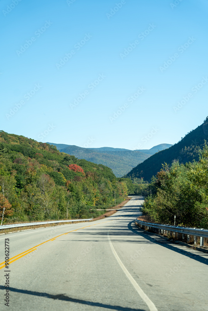 A winding road with view of mountains in White Mountain National Forest.