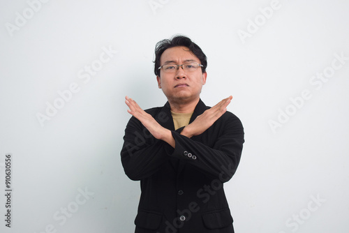 Asian Businessman with casual suit and shirt in studio showing cross hand as no or rejection, deny, prohibition with isolated white background
