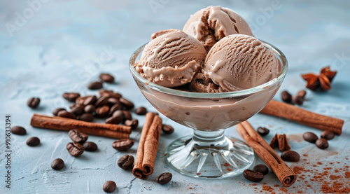 Craft an enchanting and mouthwateringly delicious photo of coffee ice cream in glass bowl, placed on the table with cacao beans and cinnamon sticks scattered around it. photo