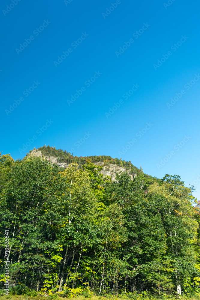 Fototapeta premium A winding road with view of mountains in White Mountain National Forest.