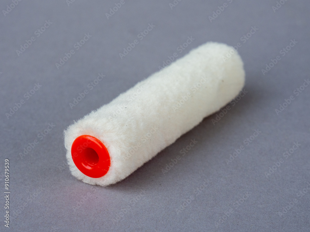 White microfiber paint roller for painting. Accessories for painters and builders. Surface painting with a roller White microfiber paint roller for painting. Accessories for painters and builders. Surface painting with a roller