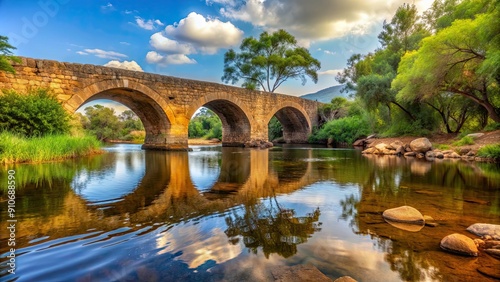 Old stone bridge over tranquil river in Uige, Angola , historical, ancient, architecture, landmark, scenic, picturesque, vintage photo