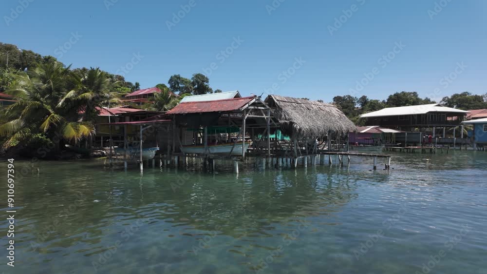 Scenic view of traditional coastal village huts over clear waters on Bastimentos Island, Bocas del Toro, Panama. Scenic view of traditional coastal village huts over clear waters on Bastimentos Island, Bocas del Toro, Panama.