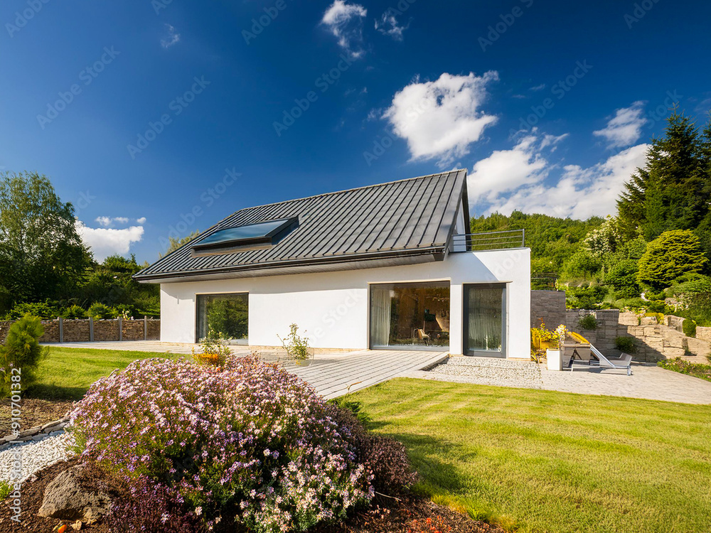 Modern single-family home in an idyllic landscape with a well-kept garden