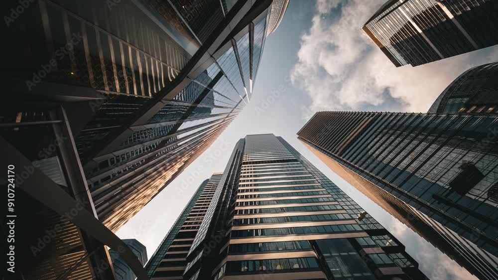 Modern business architecture with glass and steel walls reflecting sky clouds. Modern business architecture with glass and steel walls reflecting sky clouds.