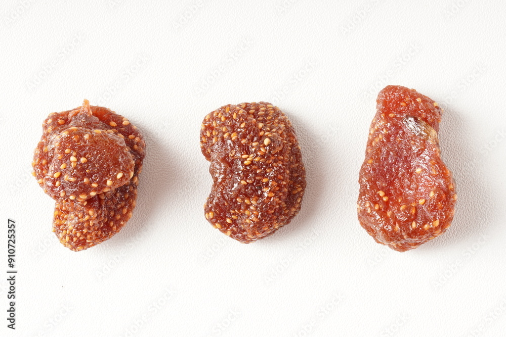Healthy snack of sweet, pale red dehydrated strawberry candy, photographed against a white background. Scientific name: Fragaria × ananassa. Healthy snack of sweet, pale red dehydrated strawberry candy, photographed against a white background. Scientific name: Fragaria × ananassa.