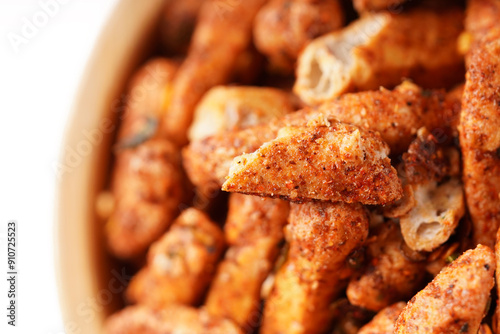 A bowl of Basreng (fried meatballs), a popular Indonesian snack made from thinly sliced fish meatballs, fried until crispy, and coated with spicy seasoning. Photographed against a white background.