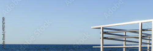 Obraz na płótnie Stainless steel balustrade against the background of the sea and clear blue sky. banner w salonie