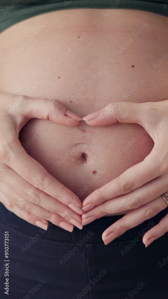 Woman, pregnant and heart hands on stomach for love, future and care for unborn baby at home. Fertility, maternity leave and closeup of belly with gesture, security and support by holding tummy Woman, pregnant and heart hands on stomach for love, future and care for unborn baby at home. Fertility, maternity leave and closeup of belly with gesture, security and support by holding tummy