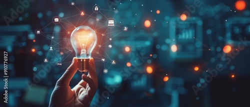 Hand holding a glowing light bulb with digital icons connecting to it.