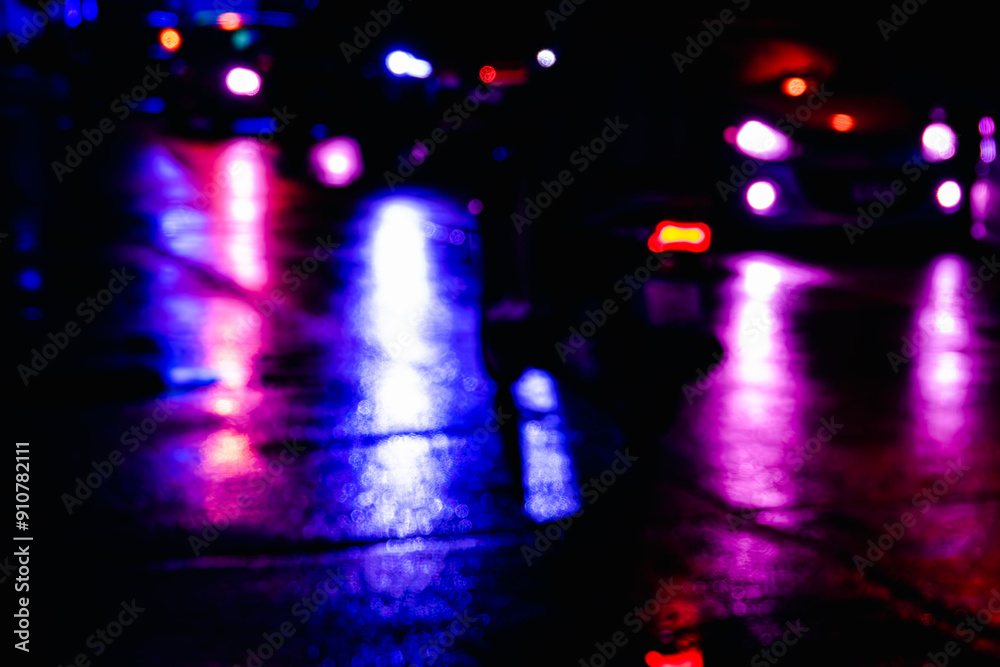 A blurry image of a street with cars and police lights. Scene is mysterious and somewhat eerie A blurry image of a street with cars and police lights. Scene is mysterious and somewhat eerie