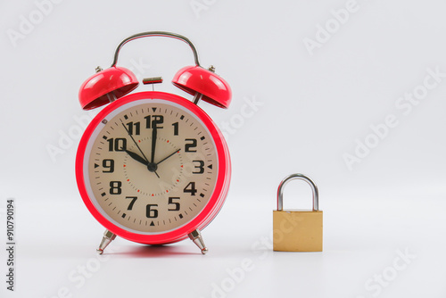 A red alarm clock and padlock isolated with white background.
