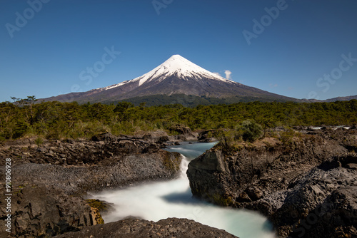 The snow-capped Osorno volcano with the amazing Petrohue Falls in the foreground, Vicente Rosales National Park, Puerto Varas, Chile. Long Exposure. photo