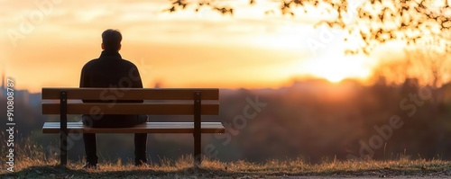 Solitary figure sitting on a park bench watching the sunrise, wrapped in a sense of peace and tranquility