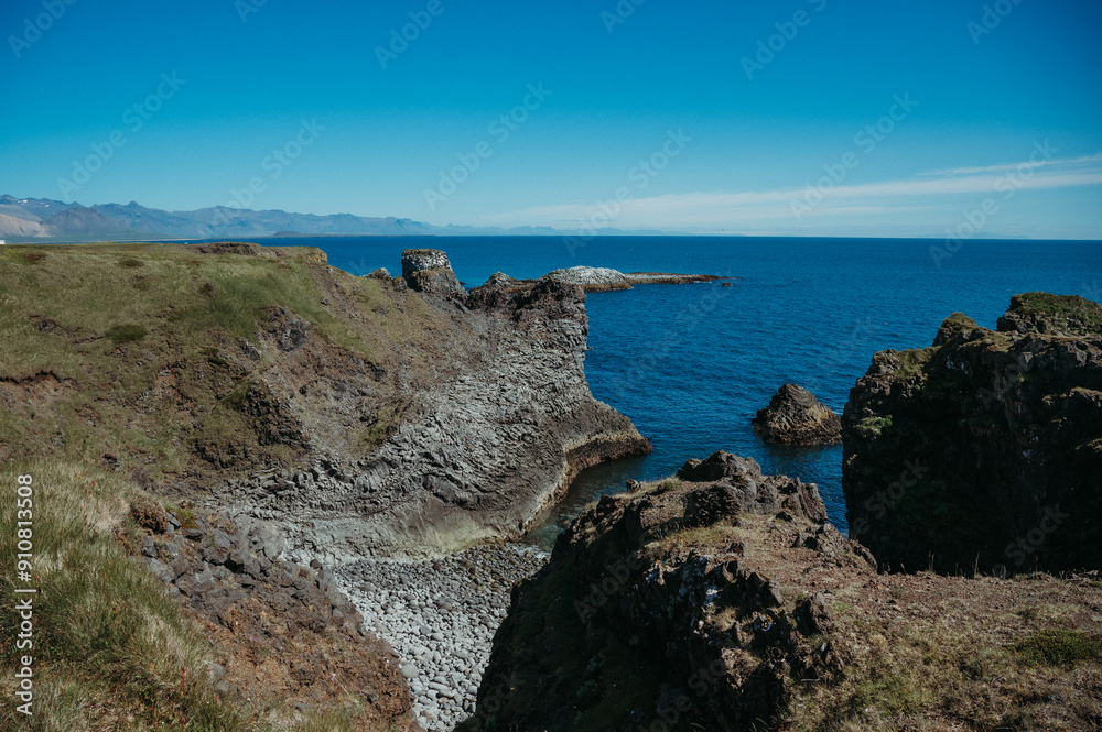 Rugged rocks in Gatklett, Iceland, with clear blue ocean waters Rugged rocks in Gatklett, Iceland, with clear blue ocean waters