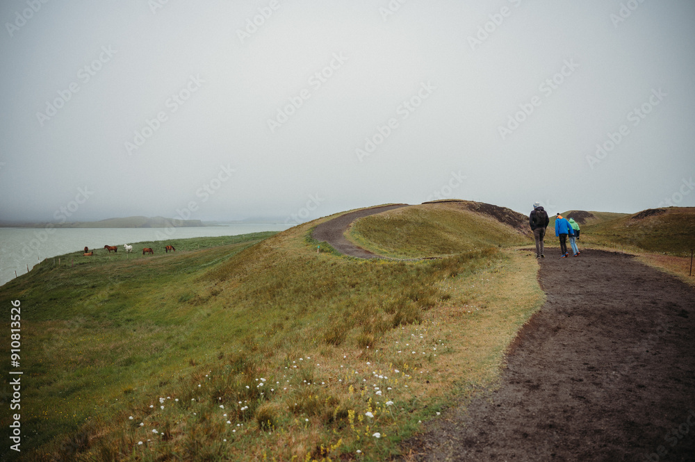 Fototapeta premium Family hiking in Myvatn, Iceland with ocean and icelandic horses