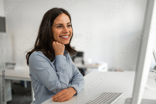 Attractive young employee looking at computer screen