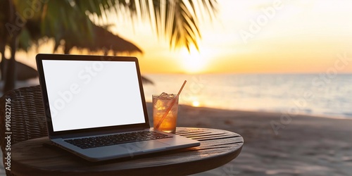 A laptop with a blank white screen on a wooden table at a beach resort photo