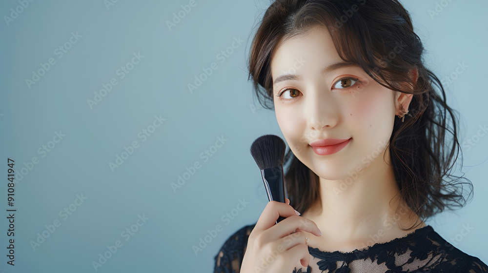 Young Japanese Woman in Black Lace Dress Holding Makeup Brush Young Japanese Woman in Black Lace Dress Holding Makeup Brush