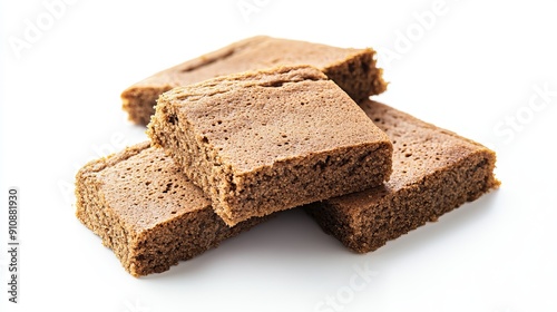 Pieces of traditional Dutch dessert cake, known as ontbijtkoek, on a white background.