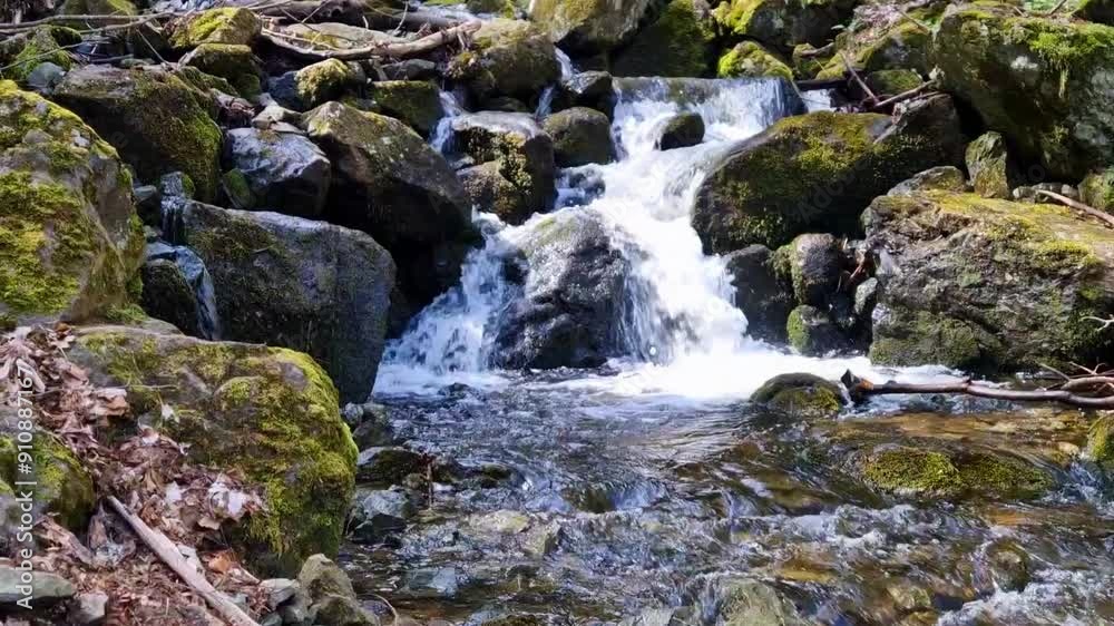 Spring time. Waterfall in the mountains with a lot of rocks around