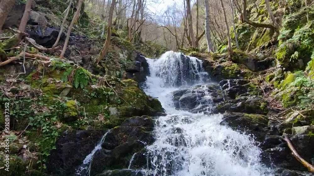 Spring time. Waterfall in the mountains with a lot of rocks around Spring time. Waterfall in the mountains with a lot of rocks around