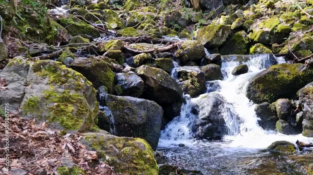 Spring time. Waterfall in the mountains with a lot of rocks around Spring time. Waterfall in the mountains with a lot of rocks around