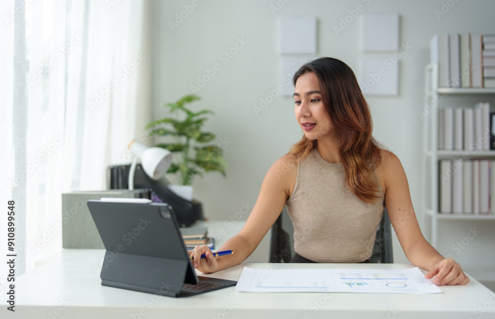 Fototapeta premium Asian businesswoman takes notes in an online meeting on the internet using her laptop. startup business idea Data Analysis, Business Owners, Marketing, Accounting, Auditing.