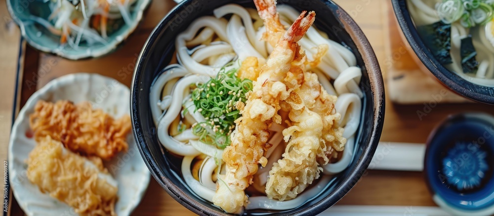 Squid tempura and udon noodles traditional Japanese cuisine are showcased in a delightful copy space image Squid tempura and udon noodles traditional Japanese cuisine are showcased in a delightful copy space image
