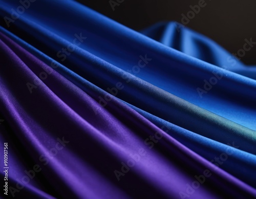 The heavy dark blue colored fabric hangs down with many folds photo